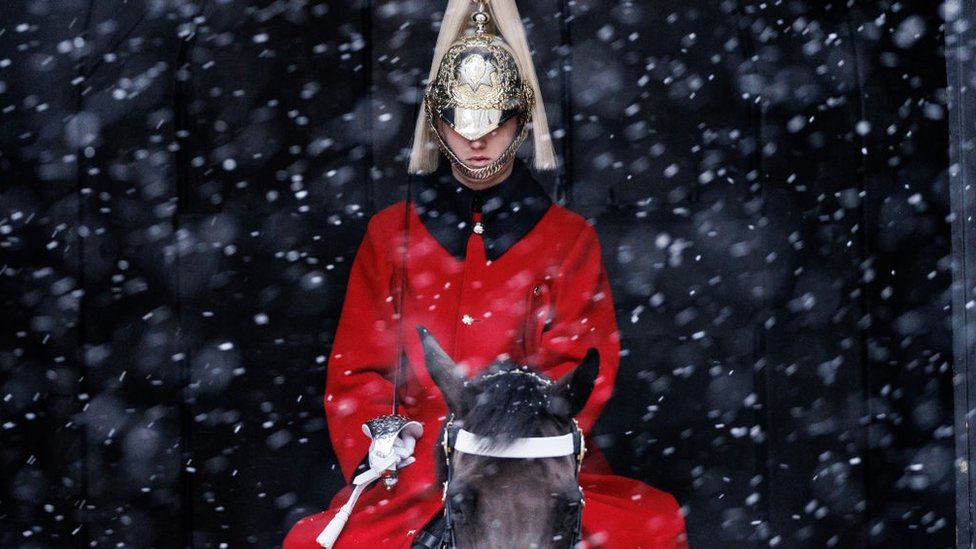 A member of Household Cavalry on his horse in the snow at Horse Guards