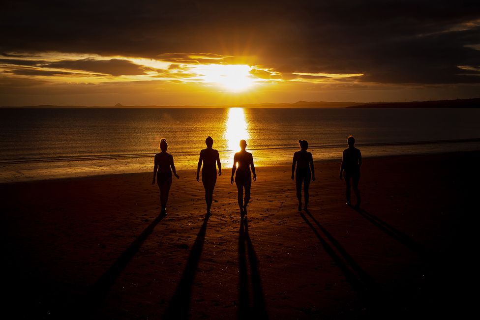 Group of people in silhouette on a beach
