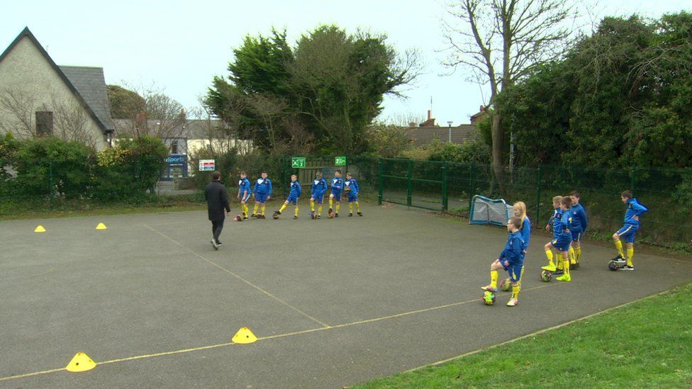 Pupils play football with Jamie Mulgrew