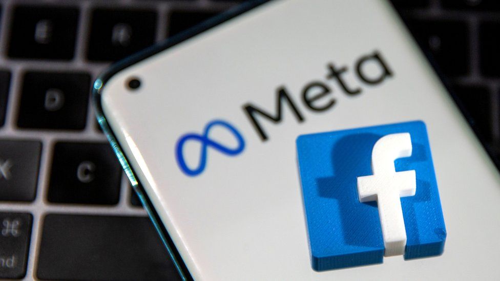 Facebook and meta logos on a keyboard