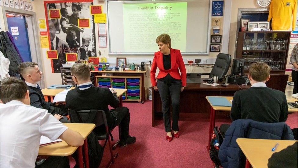 First Minister Nicola Sturgeon chatting to pupils in a Modern Studies class on November 14, 2022 in Glasgow, Scotland. T
