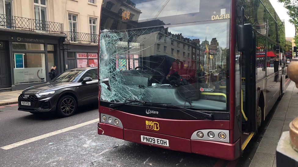 Photo showin smashed glass on a trip bus near tha scene of tha collision wit a cold-ass lil cow up in London