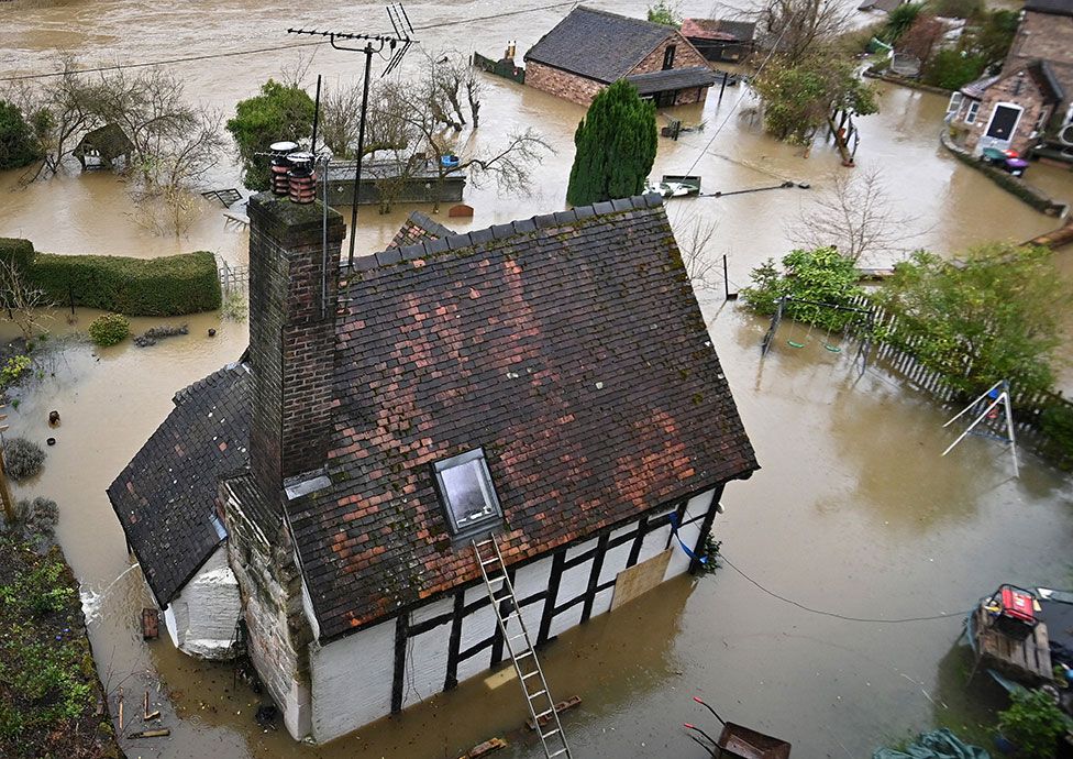 Houses in Ironbridge, Shropshire, UK, are surrounded by flood waters from the burst banks of the River Severn on 22 February 2022
