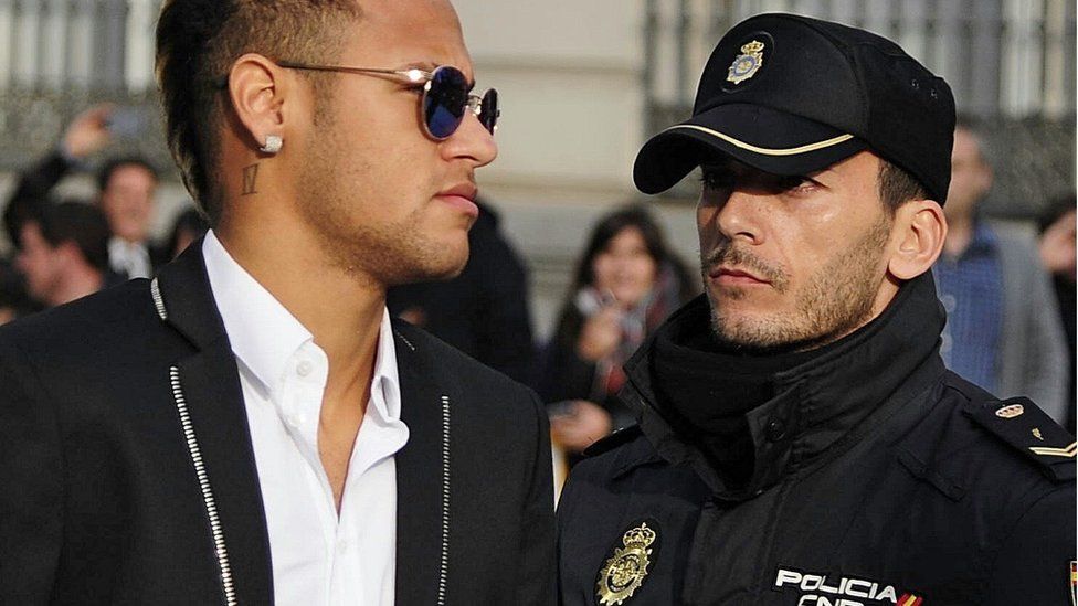 Neymar walking past a Spanish policeman