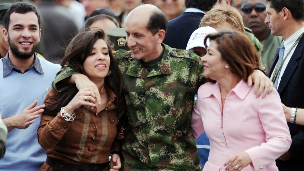 Former Revolutionary Armed Forces of Colombia (FARC) hostage Gen Luis Herlindo Mendieta (C) hugs his family upon arrival in Bogota on June 14, 2010.