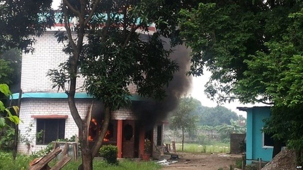 A building burns after it was set alight by protesters in the Nepalese district of Kailali, Nepal - 25 August 2015