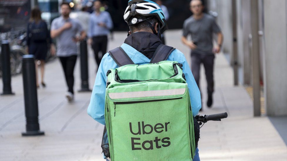 Man with Uber Eats bag on his bike.