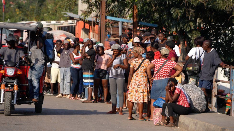 Haitians wait at the border crossing in Dajabón