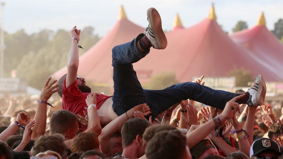 A person crowdsurfing at Reading festgival