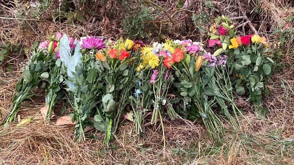 Tribute flowers left at Cotswold Water Park