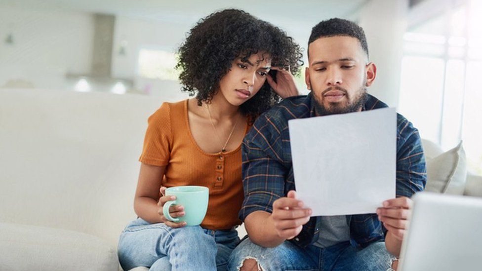 Image of couple looking at bill