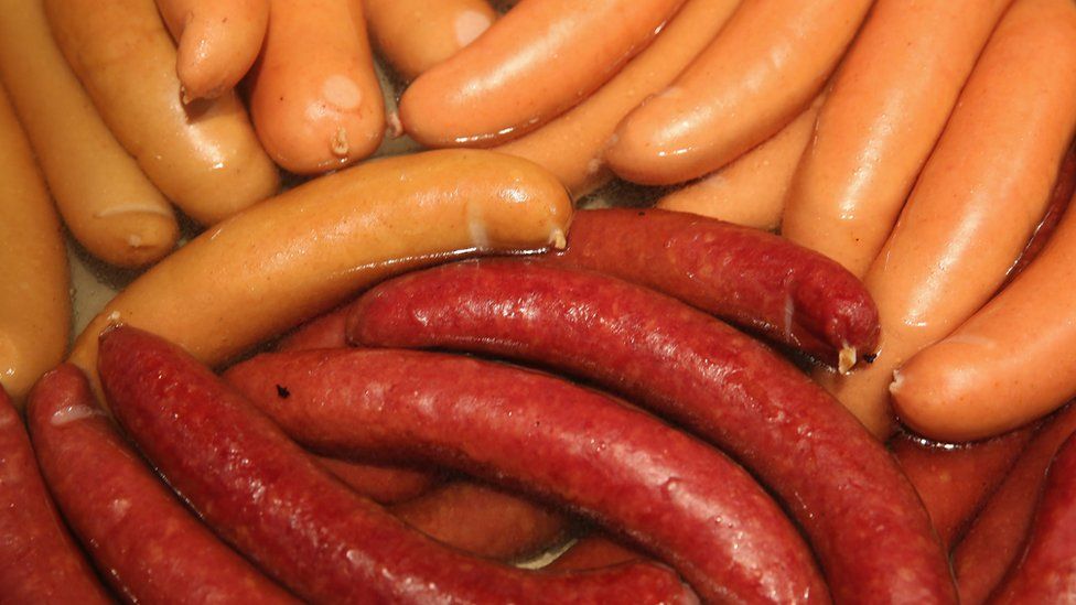 Bockwurst and krakauer sausages simmer in hot water at a stand at the International Green Week agricultural trade fair (Internationale Gruene Woche) on January 16, 2015 in Berlin, Germany.