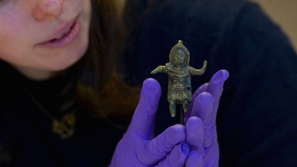 Curatorial and Learning Officer Sarah Harvey, places the Birrus Britannicus Roman figurine on display at Chelmsford Museum in Essex