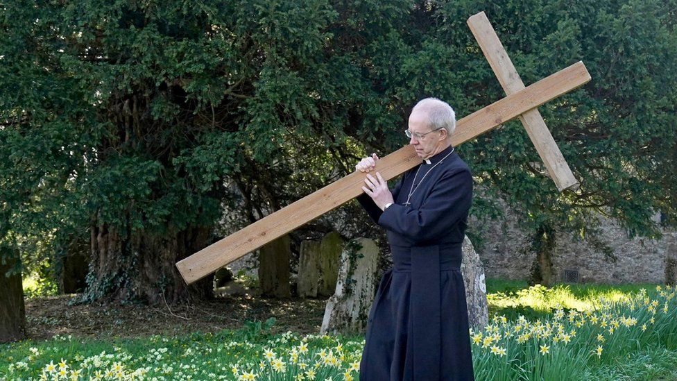 Archbishop of Canterbury Justin Welby carrying a wooden cross at St Mary's Church in Sellindge, Kent