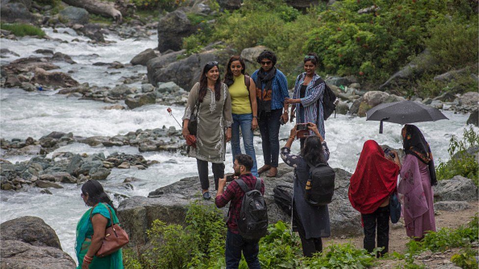 A group of Indian tourists take their pictures on September 4, 2022 in Chandanwari 112 Km ( 69 miles) south Srinagar,