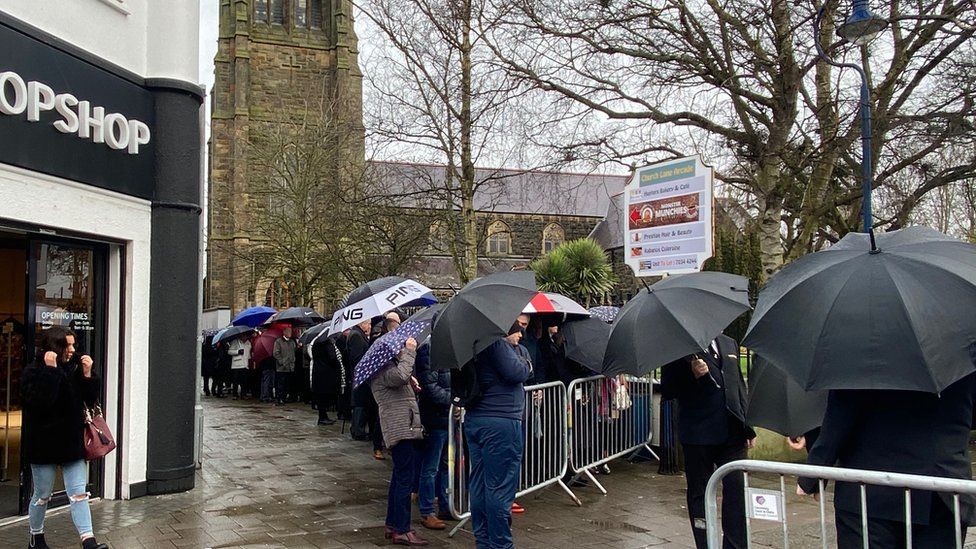 Mourners outside the funeral of Harry Gregg