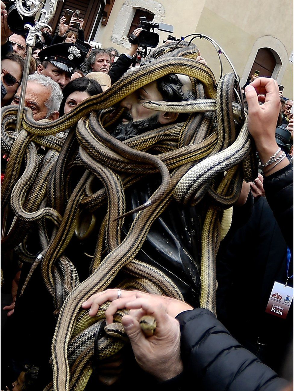 A statue of Saint Domenico covered with live snakes is carried by faithfuls during an annual procession in the streets of Cocullo