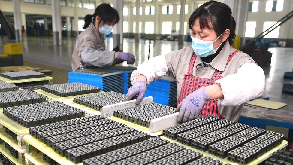 A worker produces magnetic materials at Guanyouda Magnetic Industry Co