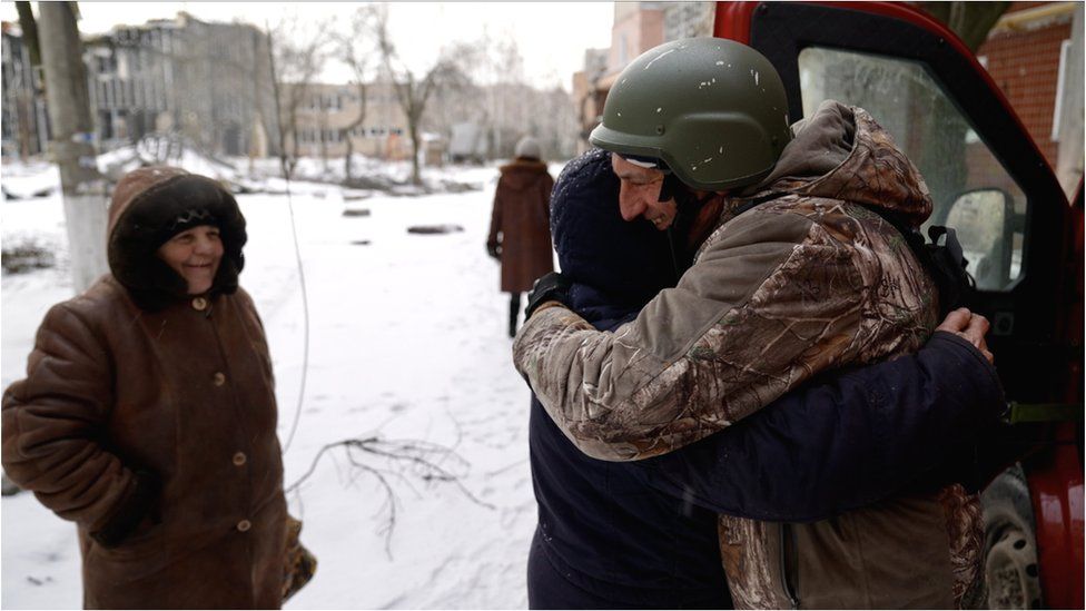 Pastor Oleh greets a local woman with a hug in the eastern Ukrainian town of Vuhledar
