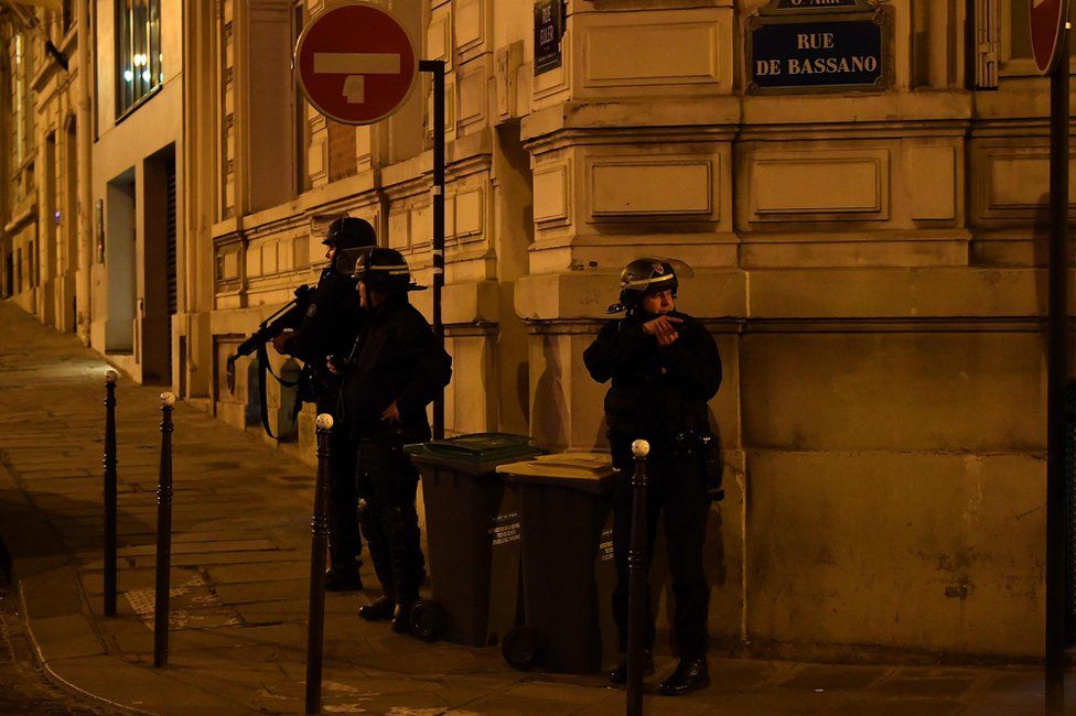 Police officers patrol near the site of a shooting at the Champs Elysees in Paris, 20 April