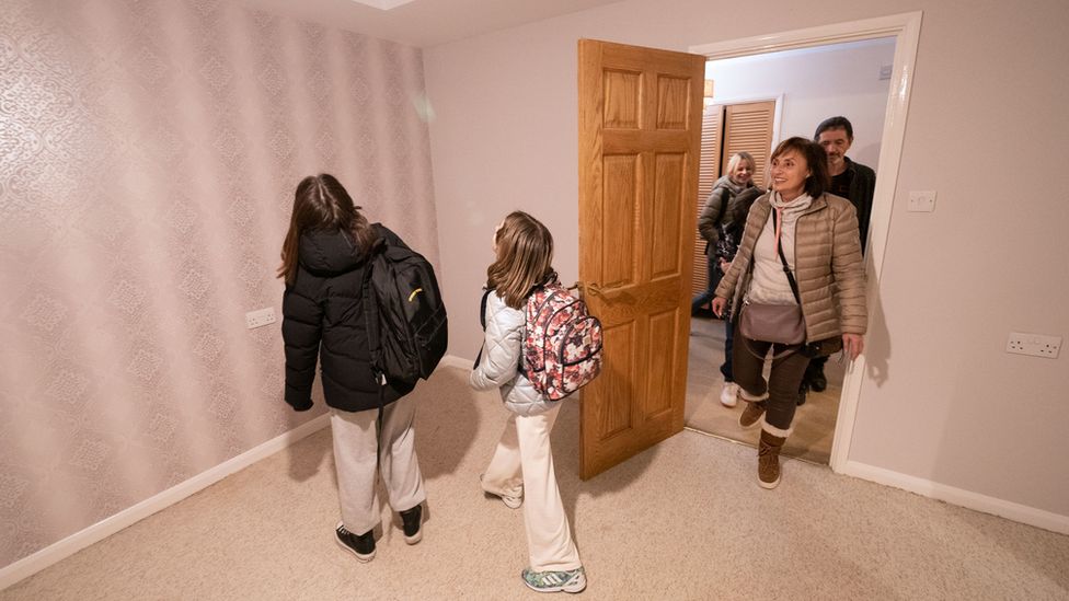 Iryna Starkova and her family look around one of the bedrooms in their new home in Caldecote near Cambridge. The family of ten who range in age from Alikhan, aged 10, to 90-year-old great grandmother Ludmila, fled Kharkiv in the Ukraine following the Russian invasion, beginning their journeys on March 1.