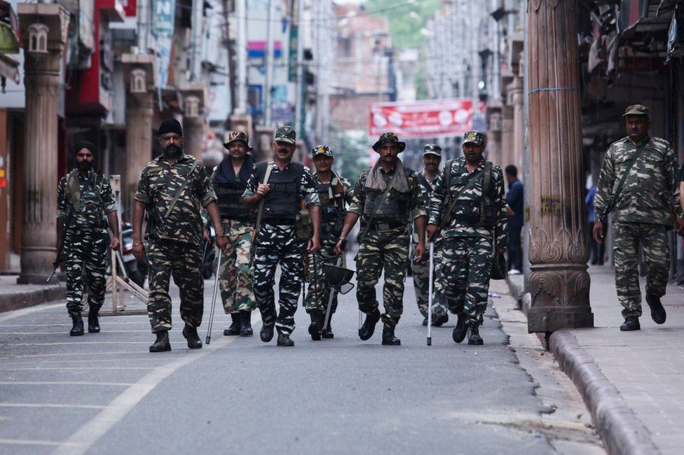 Security personnel patrol along a street in Jammu on August 6, 2019.