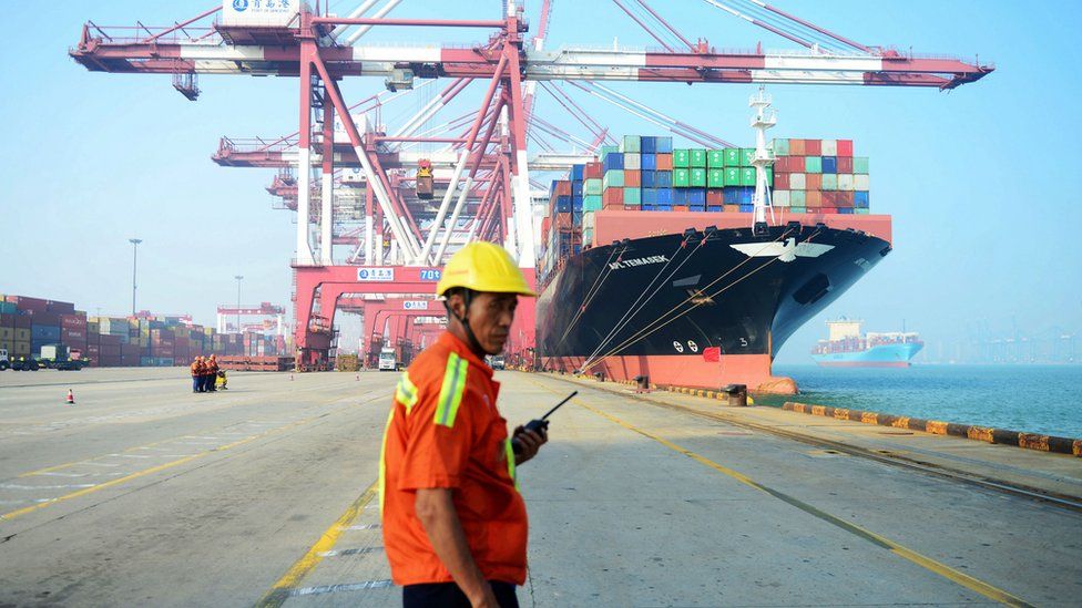 A man stands on a port in China