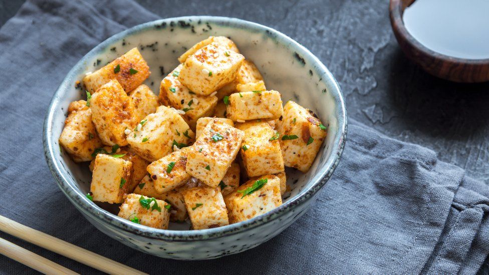 Stir Fried Tofu in a bowl with sesame and greens