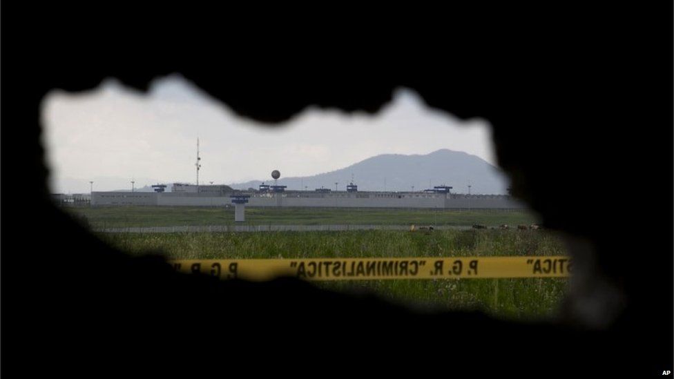 A view of the Altiplano maximum security prison through an opening in the half-built house from where authorities claim drug lord Joaquin "El Chapo" Guzman made his escape via an underground tunnel leading from his prison cell, in Almoloya, west of Mexico City, Thursday, July 16, 2015