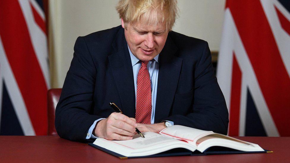 Boris Johnson signing the withdrawal agreement