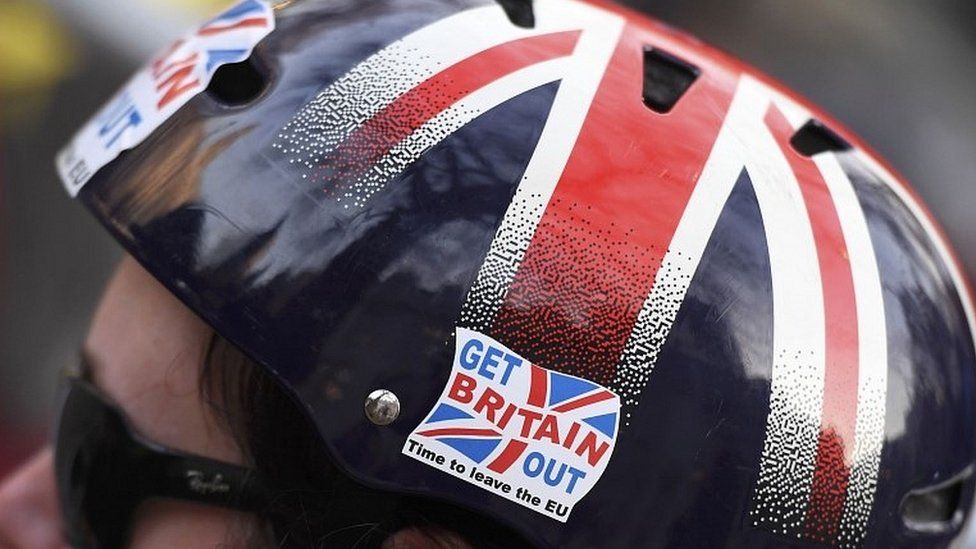 Brexit supporter wearing cycling helmet in Union Flag colours