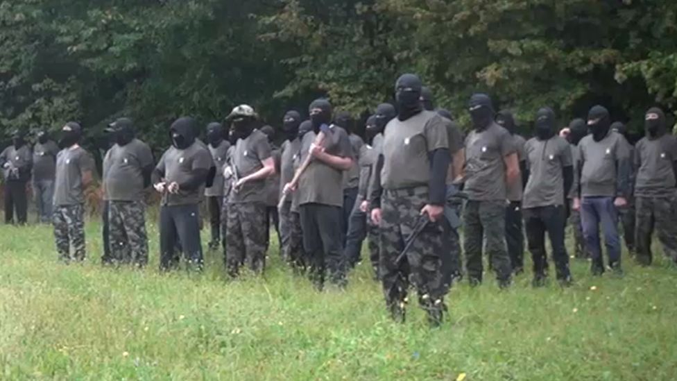 Militants pose in field