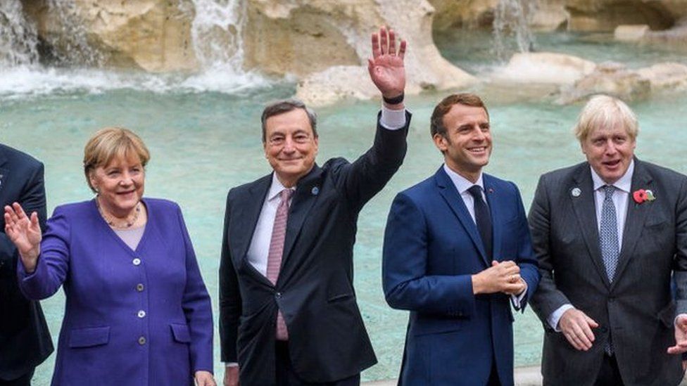 World leaders wave to the cameras in front of the Trevi fountain