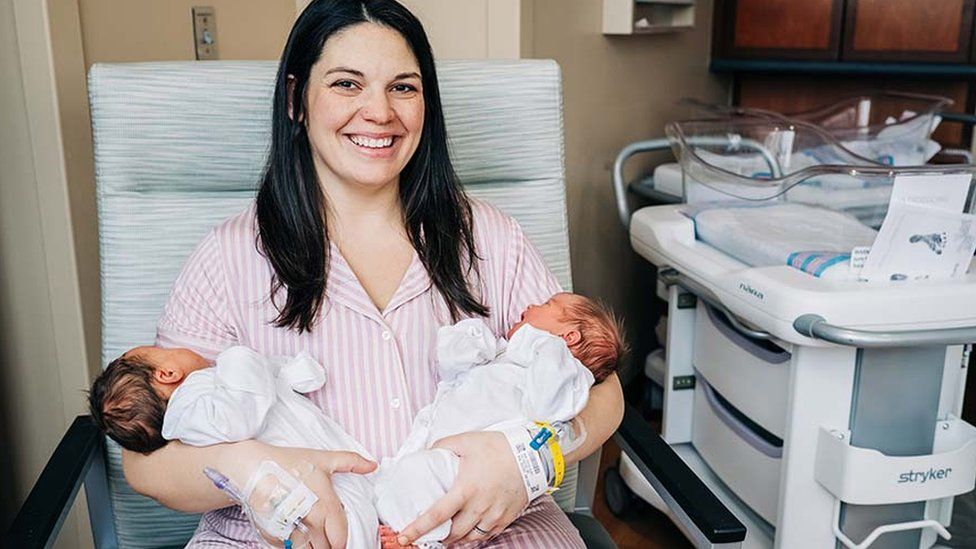 Kelsey Hatcher holds her two newborn babies