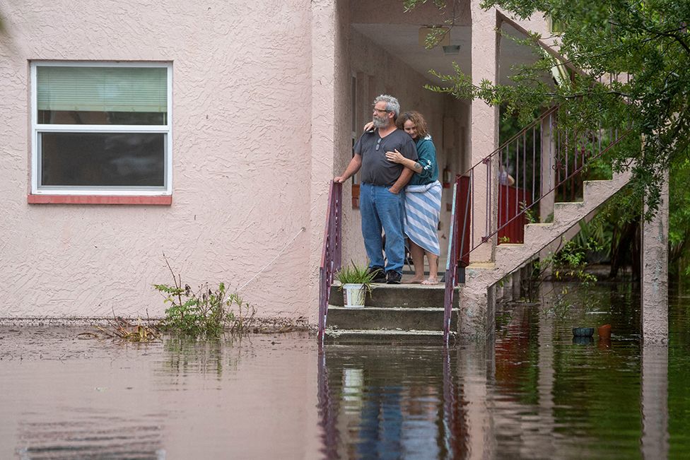 Кен и Тина Круз стоят рядом со своей квартирой после затопления территории в результате урагана Идалия в Тарпон-Спрингс, Флорида, США, 30 августа 2023 года. Грег Ловетт/USA Today Network через REUTERS.