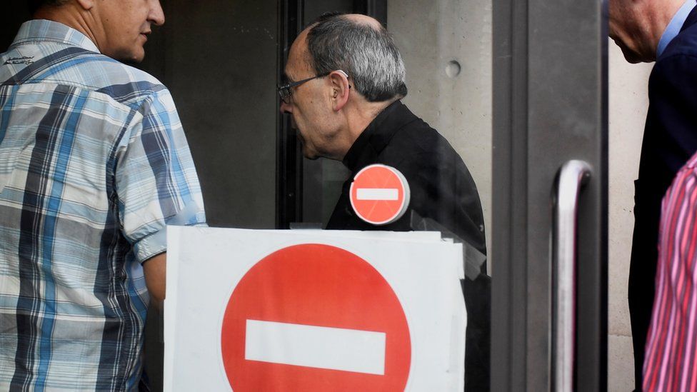 Cardinal Barbarin arrives at a police station in Lyon early on 8 June
