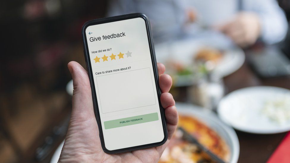 A stock image of someone leaving a review