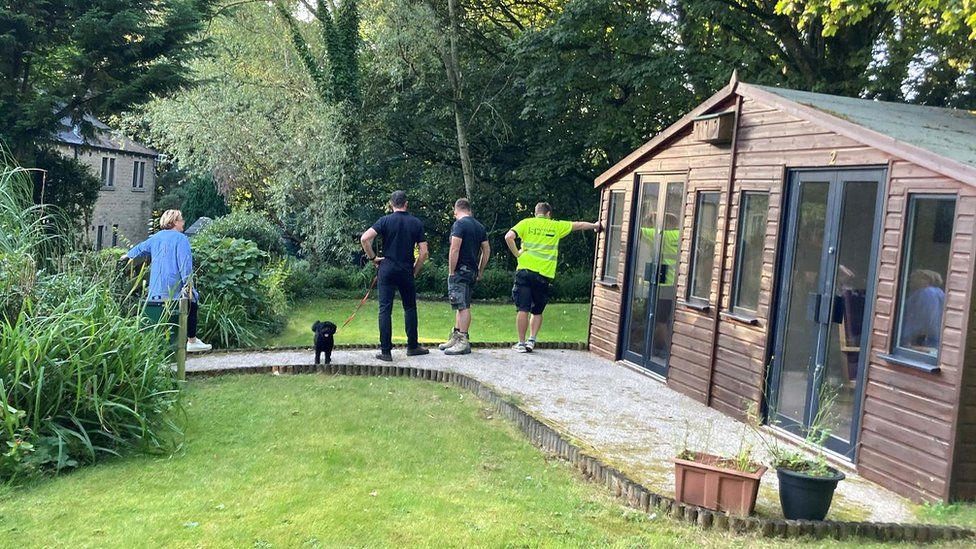 Oxenhope Volunteer and building buddies create hospice garden BBC News