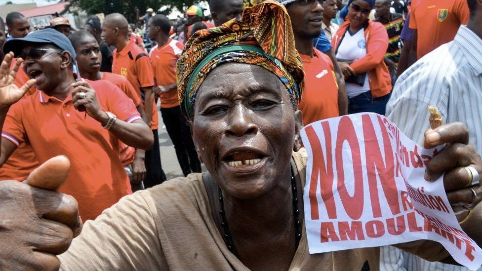 A demonstrator takes part in a protest against the third term of the Guinean President