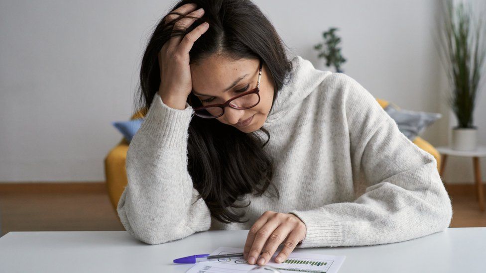 Woman looking at energy bill