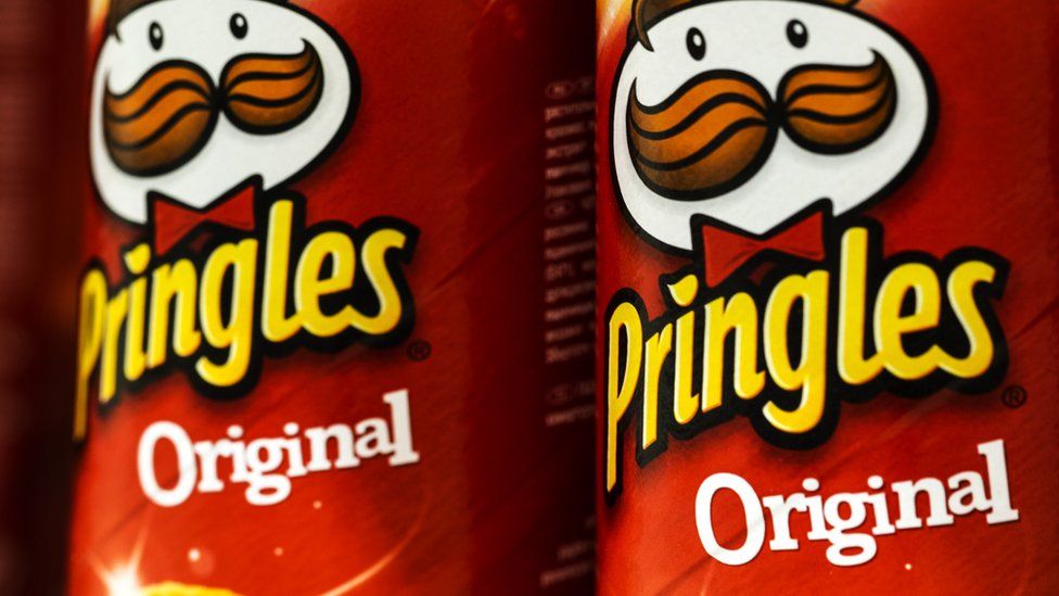 A stock image shows a close-up of two tins of original flavour Pringles crisps.