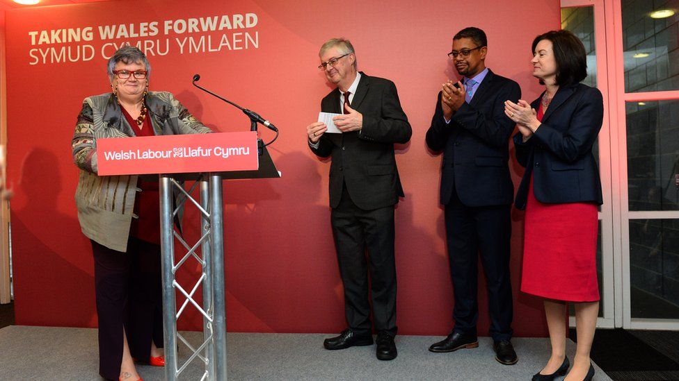 Candidates congratulate Mark Drakeford on stage