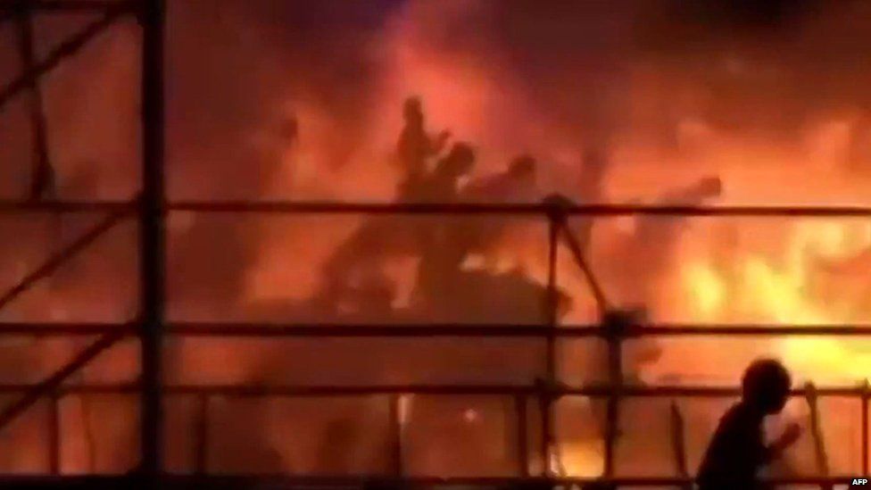 This frame grab from video footage provided by Apple Daily from reader Miss Huang on Sunday, 2015 shows revellers being engulfed by flames at the Formosa Fun Coast water park in Taipei on Saturday