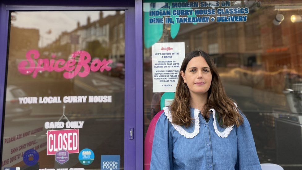 Grace Regan standing in front of the notice of closure in the window of Spice Box restaurant in Walthamstow.