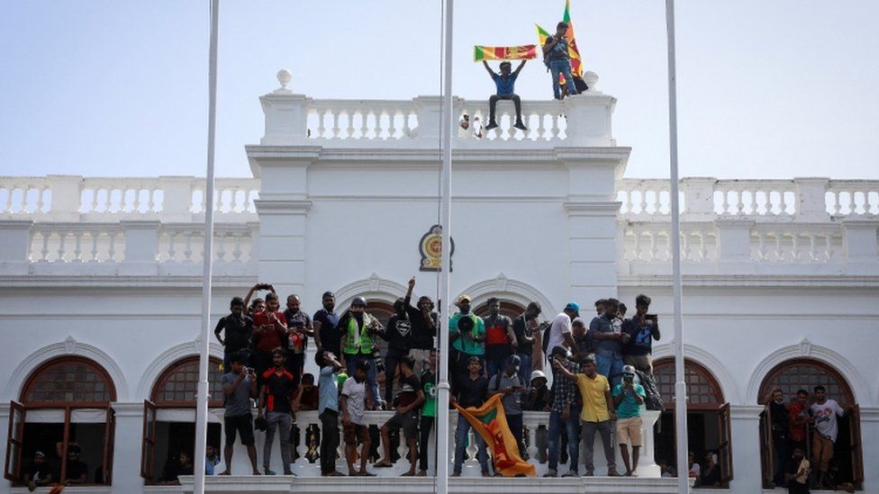 Protesters celebrate after storming the prime minister's office in Colombo, Sri Lanka