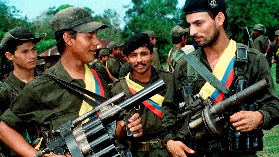 Guerrilla fighters the Revolutionary Armed Forces of Colombia (FARC) pose with their weapons after a patrol in the jungle near the town of Miraflores, Colombia, August 7, 1998