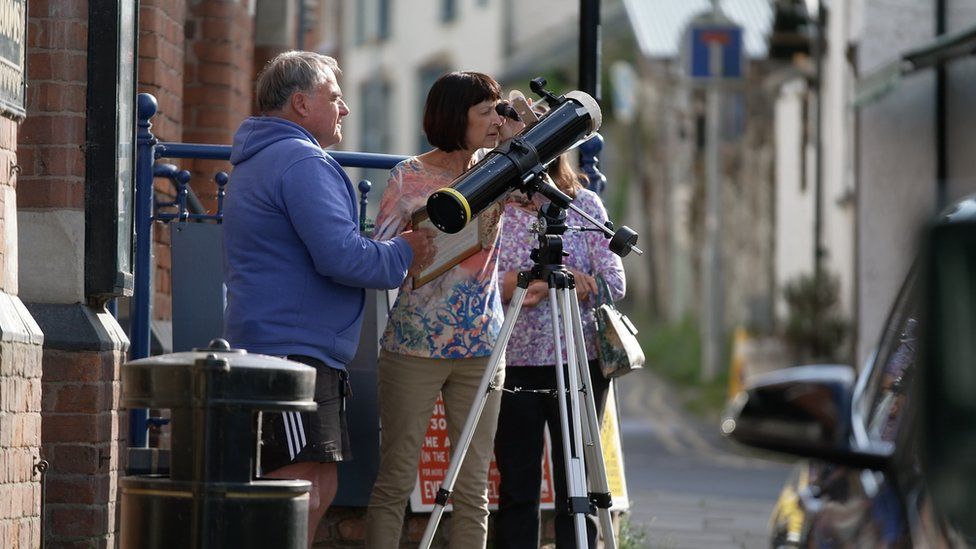 Residents in Presteigne looking into a telescope