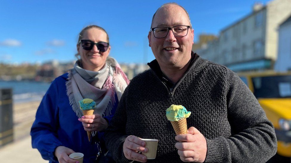 Richard Karran and partner in Peel holding blue and yellow ice creams