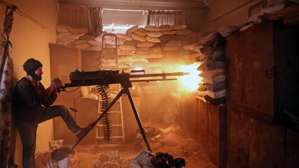 AN opposition fighter from the Failaq al-Rahman brigade fires a heavy machine gun in Jobar, a rebel-held district on the eastern outskirts of the Syrian capital Damascus, on March 19, 2017