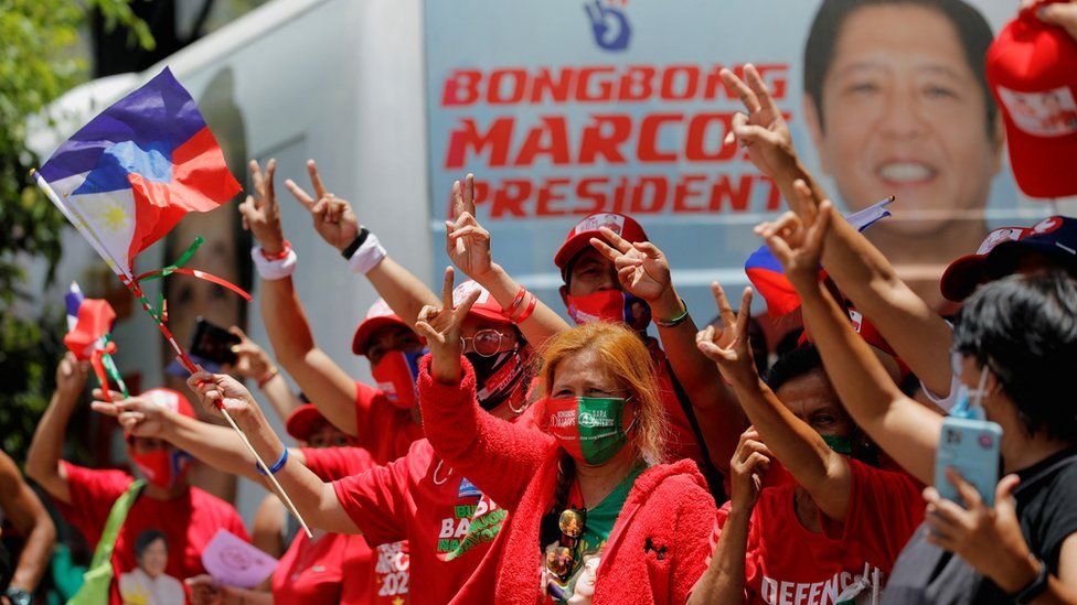 Supporters of presidential candidate Ferdinand "Bongbong" Marcos Jr. gesture and celebrate